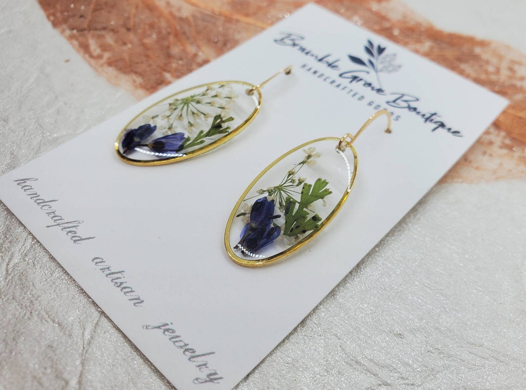 Beautiful Earrings made with preserved florals and ferns in a gold oval bezel.