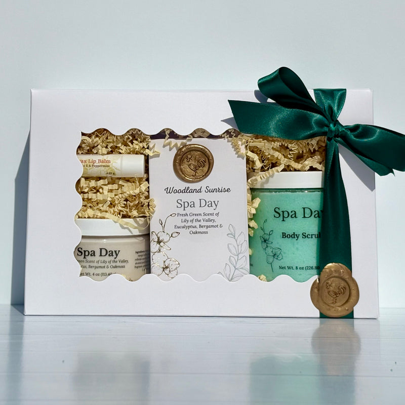 Spa gift set with lip balm, body scrub, and green ribbon on a white background
