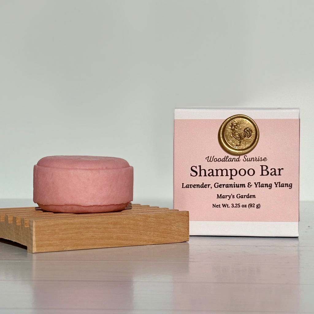 Pink shampoo bar on a wooden stand with a pink label in the background