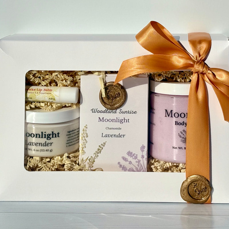 Gift set with 'Moonlight' products and a gold ribbon on a white background
