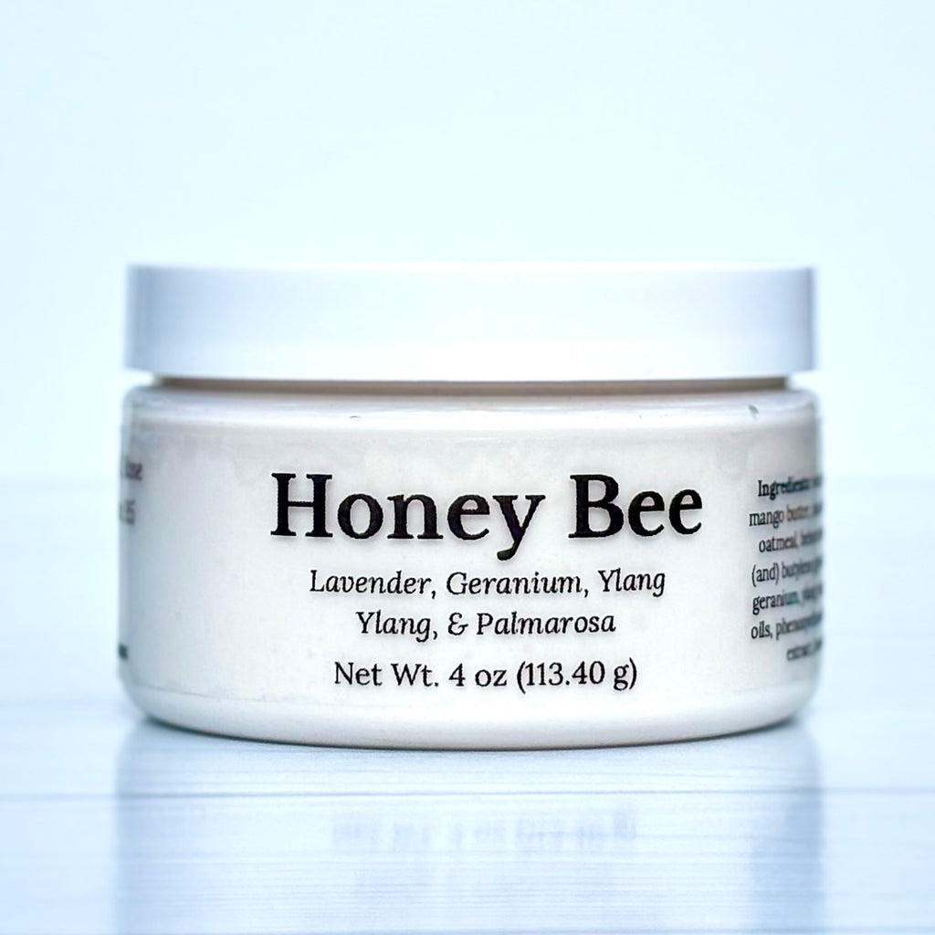 Jar of Honey Bee product with white lid and label on a light blue background