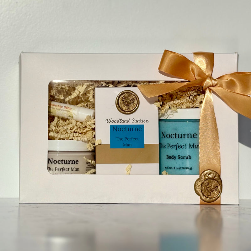 Gift set with 'Nocturne The Perfect Man' products and a gold bow on a white background
