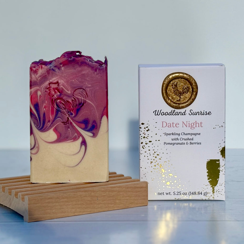 Marbled soap bar on a wooden stand with 'Woodland Sunrise Date Night' packaging in the background.