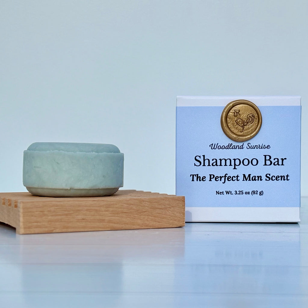 Shampoo bar with packaging labeled 'Woodland Sunrise' on a light blue background