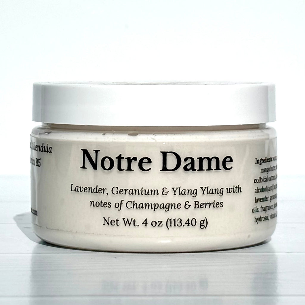 Jar of Notre Dame cream with white lid on a light gray background