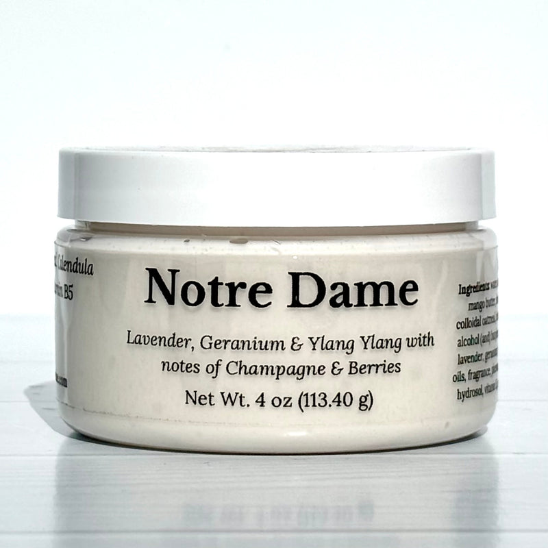Jar of Notre Dame cream with white lid on a light gray background
