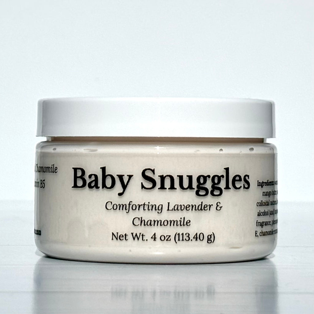 Jar of 'Baby Snuggles' cream with lavender and chamomile on a white background