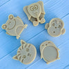Set of four animal-shaped cookie cutters soap on a blue wooden surface