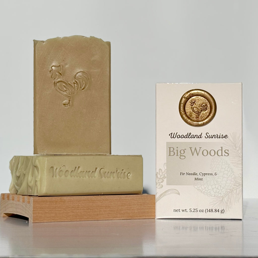 Two bars of soap and their packaging on a gray background