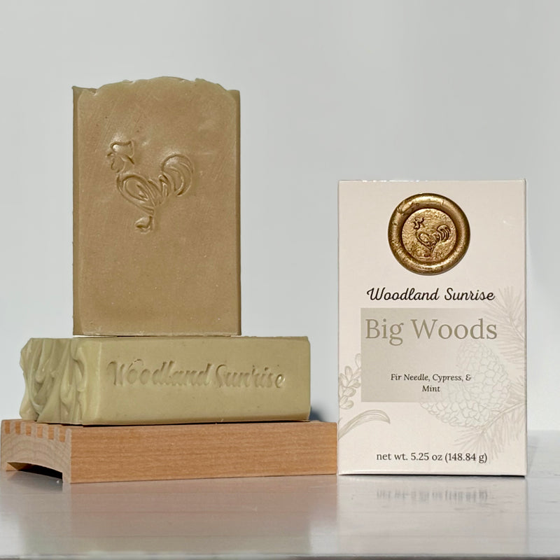 Two bars of soap and their packaging on a gray background