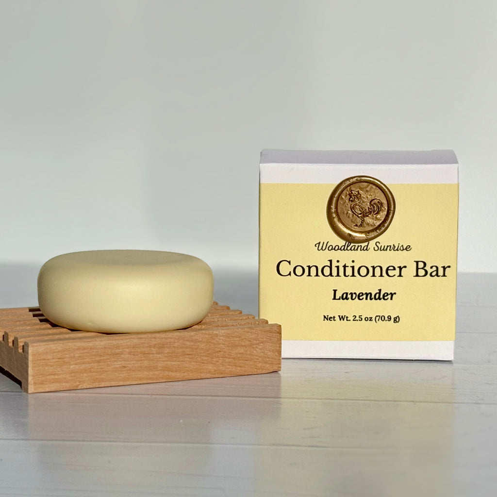 Conditioner bar with packaging labeled 'Woodland Sunrise' on a neutral background
