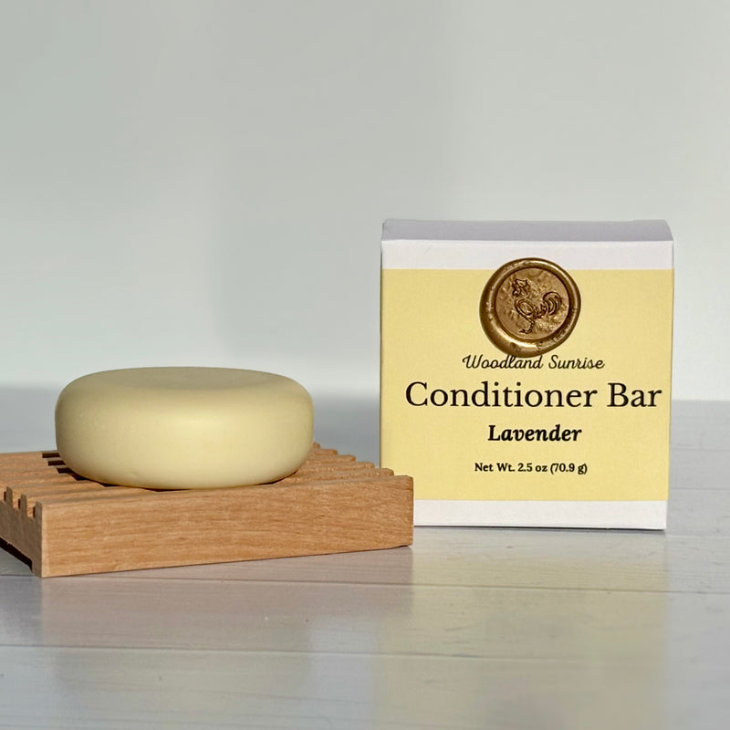 Conditioner bar with packaging labeled 'Woodland Sunrise' on a neutral background