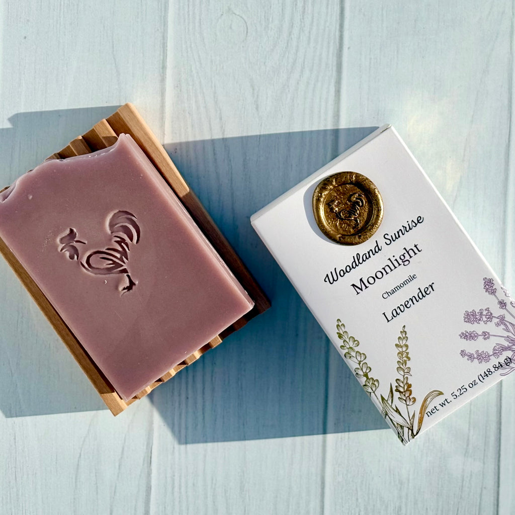 Bar of soap with a decorative box on a light wooden surface