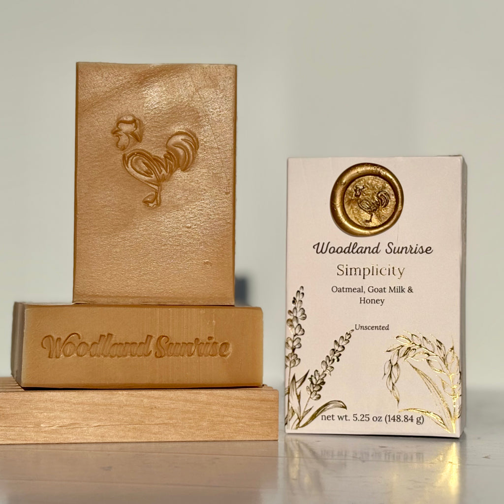 Woodland Sunrise soap bars and packaging on a reflective surface with a neutral background