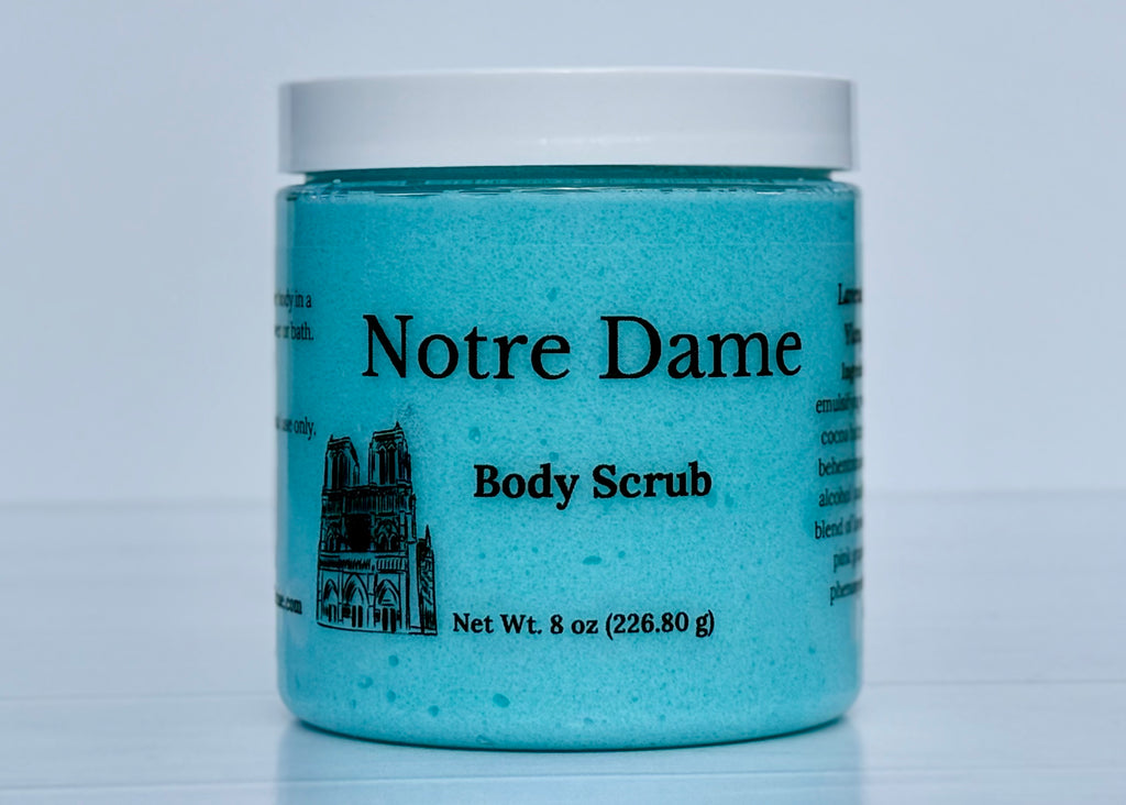 Blue jar of Woodland Sunrise Notre Dame Body Scrub on a white background. 